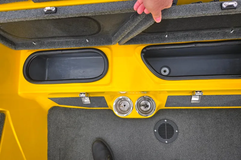 Slide: The Image of 2016 Bass Cat Caracal boat storage compartments with yellow finish and carpeted interior. - 16