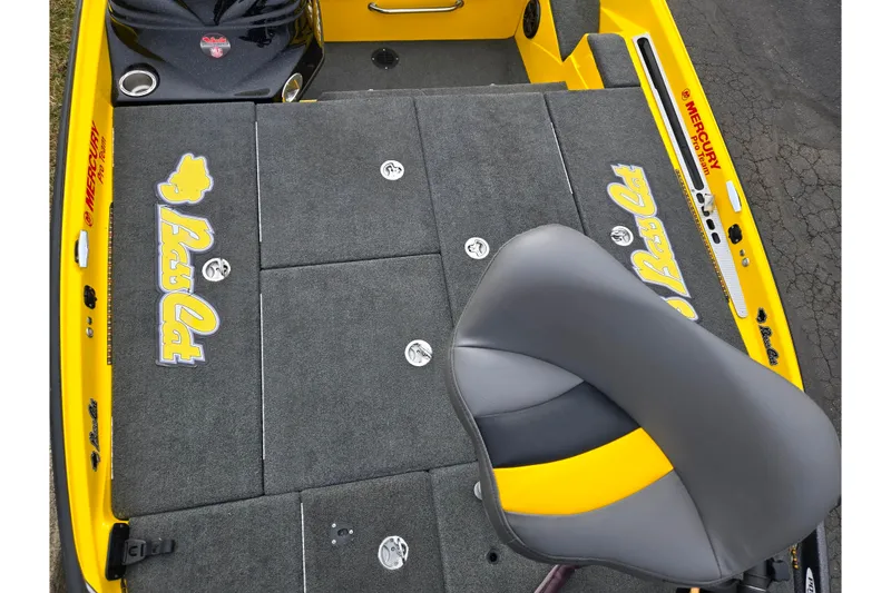 Slide: The Image of 2016 Bass Cat Caracal boat deck with gray carpet and yellow accents. - 21