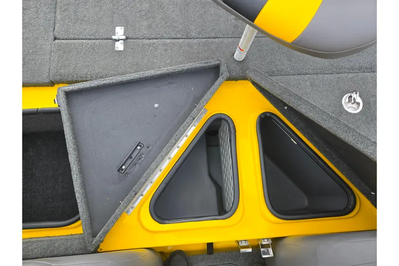 Slide: The Image of 2016 Bass Cat Caracal boat storage compartments with open lids, featuring yellow and gray interior. - 25
