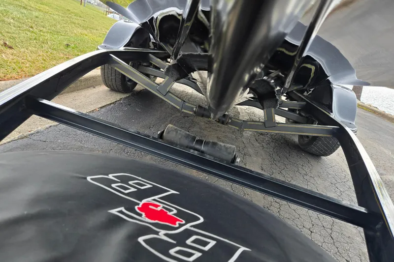 Slide: The Image of Underneath view of a 2016 Bass Cat Caracal boat trailer, showcasing suspension and tire details. - 7