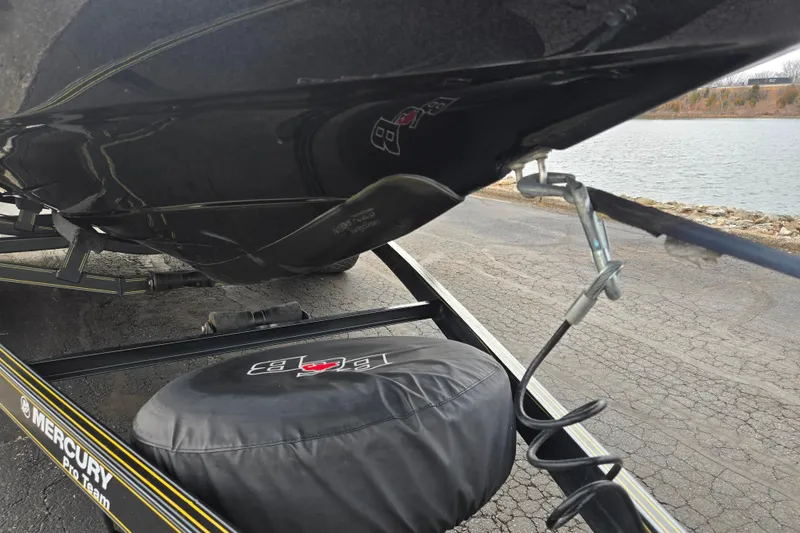 Slide: The Image of 2016 Bass Cat Caracal boat on trailer near water, featuring Mercury Pro Team branding. - 9