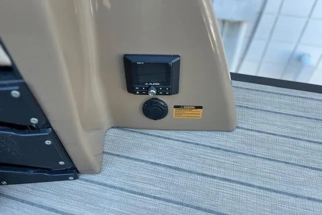 Slide: The Image of 2026 Godfrey Monaco 255 SFLC boat dashboard with audio controls and warning label. - 11