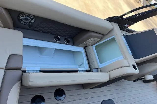 Slide: The Image of 2026 Godfrey Monaco 255 SFLC boat interior with storage compartments and beige seating. - 12