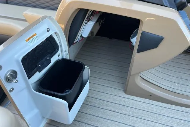 Slide: The Image of 2026 Godfrey Monaco 255 SFLC boat interior with open storage compartment and trash bin. - 18