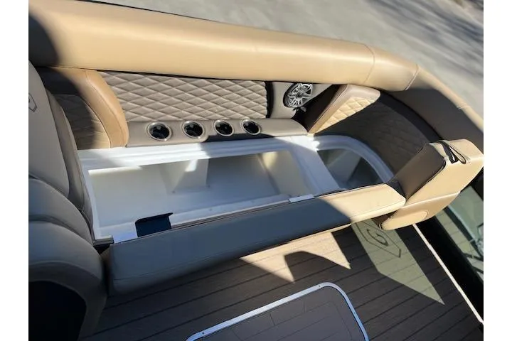 Slide: The Image of 2026 Godfrey Monaco 255 SFLC boat interior with beige seating and built-in cup holders. - 27