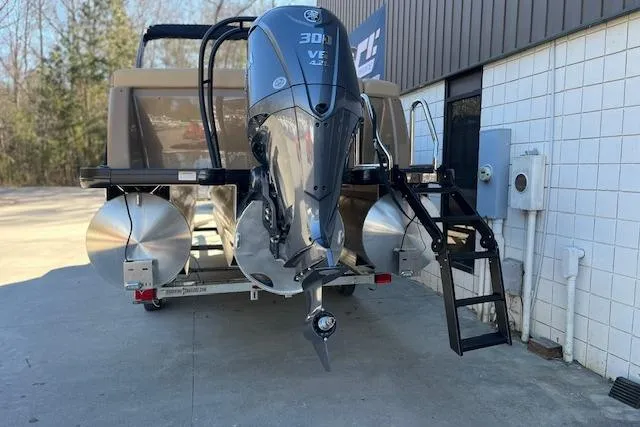 Slide: The Image of 2026 Godfrey Monaco 255 SFLC pontoon boat with powerful outboard motor, docked outdoors. - 3