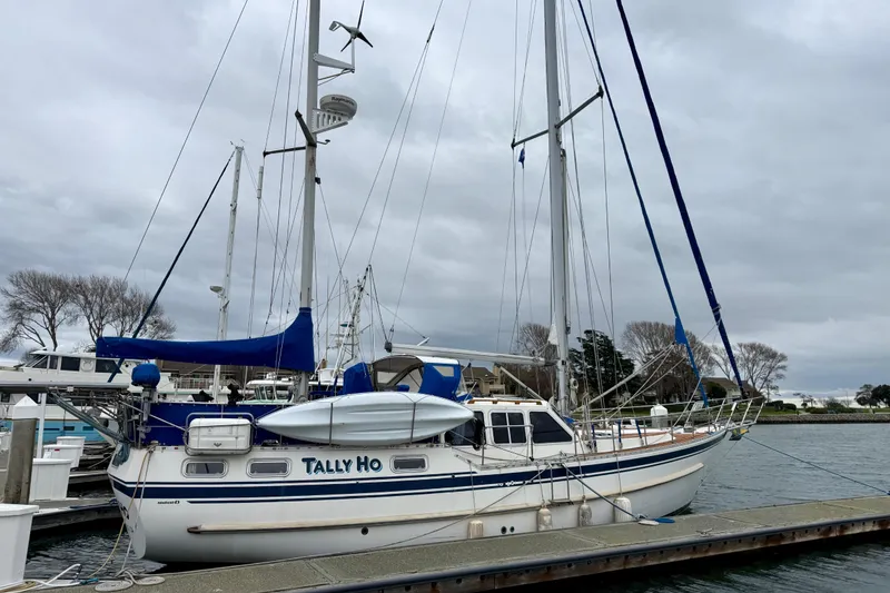 Slide: The Image of "TALLY HO," dockside with blue and white accents. - 1