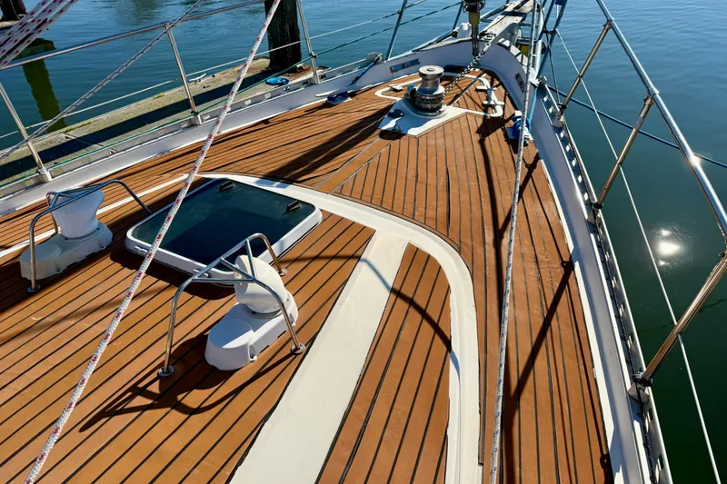 Slide: The Image of Deck of 1986 Nauticat 43 sailboat with FlexiTeak decking and metal railings. - 13