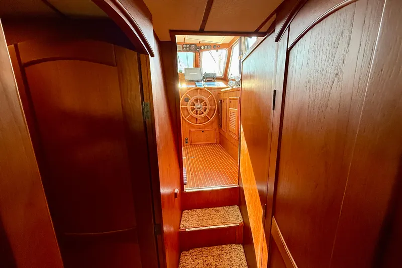 Slide: The Image of Interior of 1986 Nauticat 43 sailboat with wooden helm and cabinetry. - 44