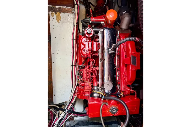 Slide: The Image of Engine of a 1986 Nauticat 43 sailboat, featuring red components and wiring. - 46