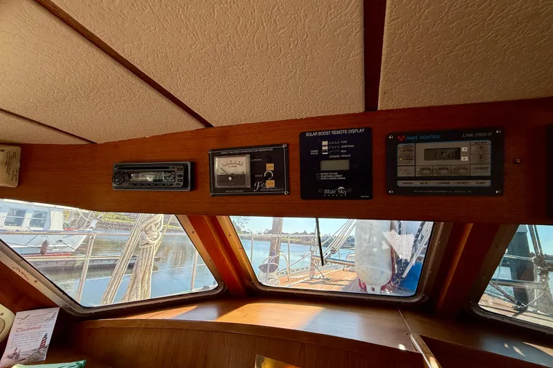Slide: The Image of Interior of 1986 Nauticat 43 sailboat with control panels and marina view. - 52
