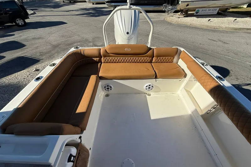 Slide: The Image of 2026 Key West 239 DFS boat interior with brown cushioned seating and white deck. - 10