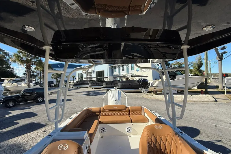 Slide: The Image of 2026 Key West 239 DFS boat interior with tan seating, docked at a marina. - 11