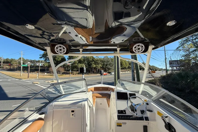 Slide: The Image of 2026 Key West 239 DFS boat interior with steering wheel, dashboard, and road view. - 12