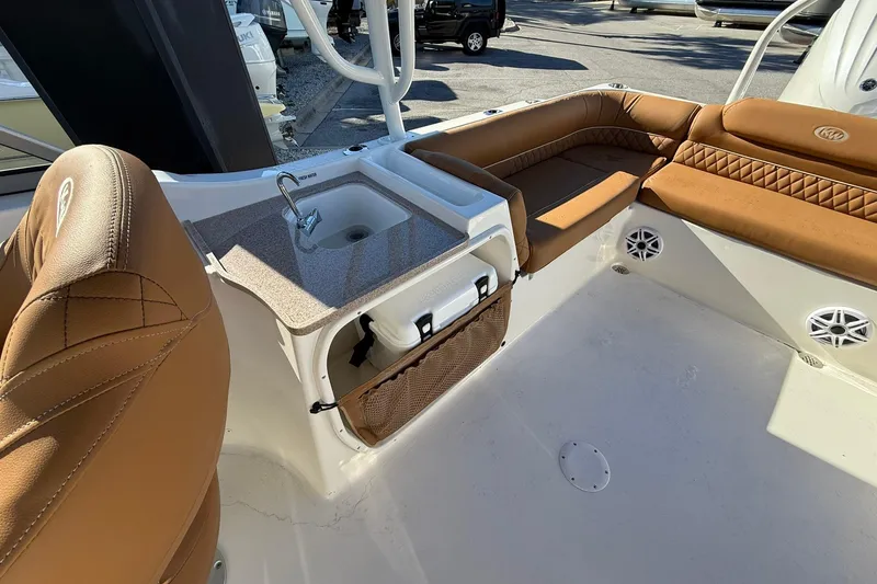 Slide: The Image of 2026 Key West 239 DFS boat interior with sink and tan seating. - 9