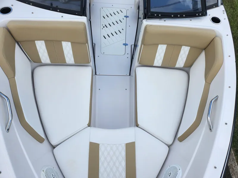 Slide: The Image of 2016 Glastron GT 205 boat interior with beige and white seating. - 18