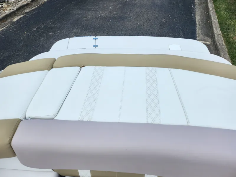 Slide: The Image of 2016 Glastron GT 205 boat interior with beige and white upholstery. - 22