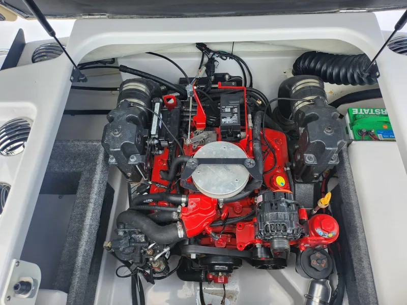 Slide: The Image of 2016 Glastron GT 205 engine compartment with red engine and components. - 24