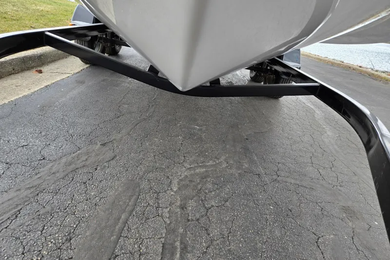 Slide: The Image of 2016 Glastron GT 205 boat on trailer, close-up view of hull and pavement. - 7