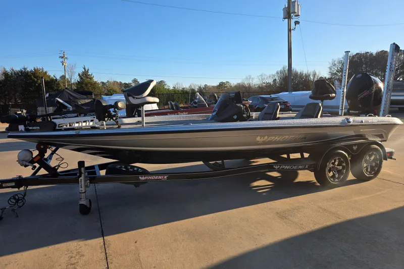 The Image of 2020 Phoenix 921 Elite boat on trailer, parked outdoors under clear blue sky. - 1