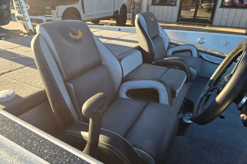 Slide: The Image of 2020 Phoenix 921 Elite boat interior with plush seating and steering wheel. - 11