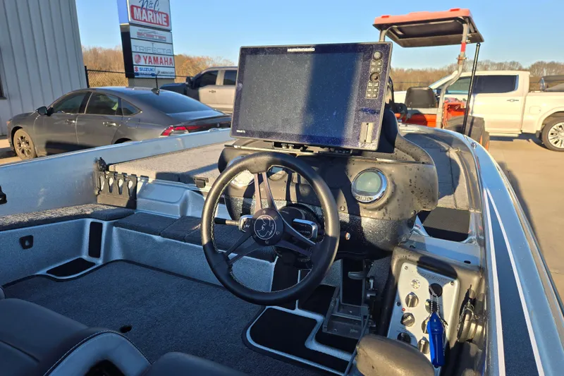 Slide: The Image of Interior of a 2020 Phoenix 921 Elite boat with steering wheel and navigation system. - 12