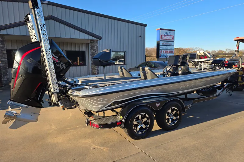 Slide: The Image of 2020 Phoenix 921 Elite boat with powerful engine, parked outside a marine dealership. - 7