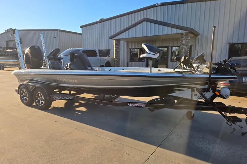 Slide: The Image of 2020 Phoenix 921 Elite boat parked outside a building on a sunny day. - 8