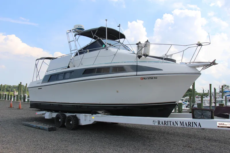 The Image of 1995 Carver 330 Mariner yacht on trailer at Raritan Marina, clear sky background. - 1