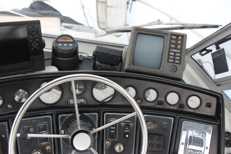 Slide: The Image of 1995 Carver 330 Mariner helm with navigation instruments and steering wheel. - 13