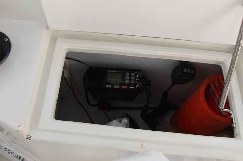 Slide: The Image of Storage compartment on a 1995 Carver 330 Mariner with radio equipment and safety gear. - 14