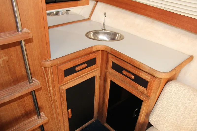 Slide: The Image of 1995 Carver 330 Mariner interior with wooden cabinetry and compact sink. - 30