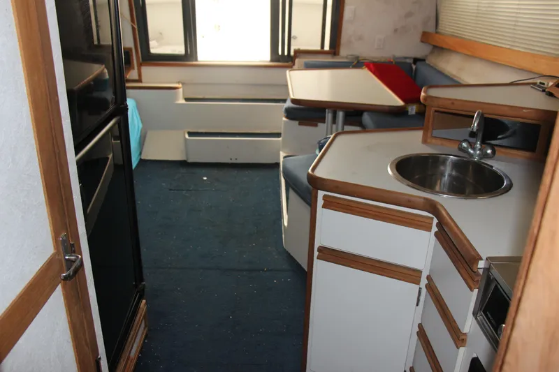 Slide: The Image of 1995 Carver 330 Mariner interior with kitchenette and seating area. - 49