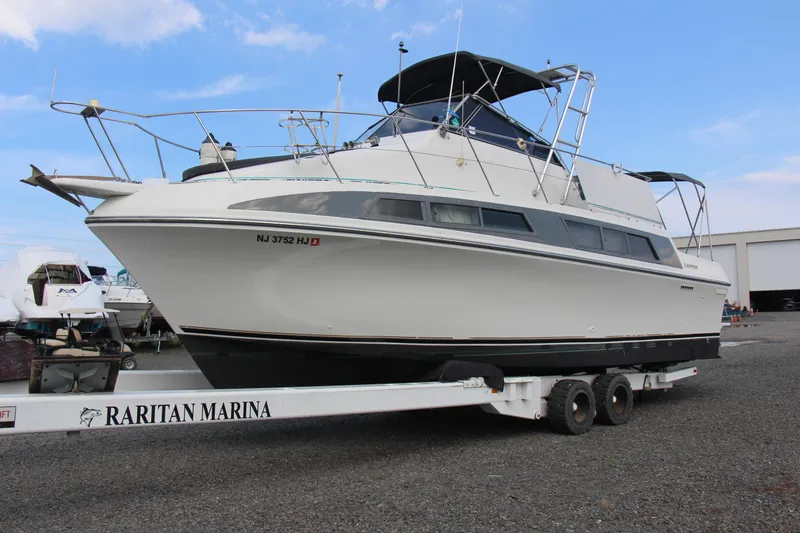 Slide: The Image of 1995 Carver 330 Mariner yacht on trailer at Raritan Marina, clear sky background. - 8