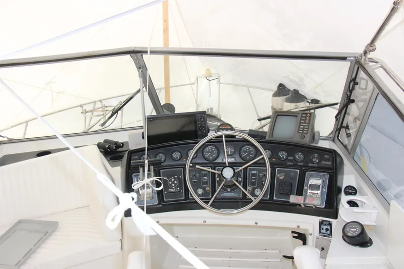 Slide: The Image of 1995 Carver 330 Mariner helm with steering wheel and navigation instruments. - 11