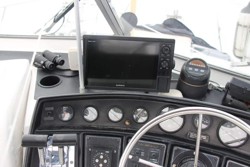 Slide: The Image of 1995 Carver 330 Mariner helm with Garmin GPS, gauges, and binoculars. - 12