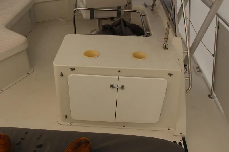 Slide: The Image of 1995 Carver 330 Mariner boat interior with seating and storage cabinet. - 18