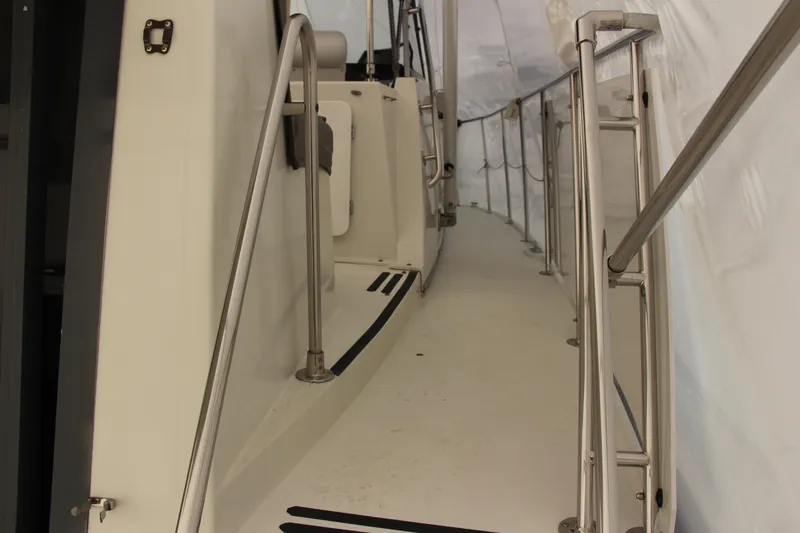 Slide: The Image of 1995 Carver 330 Mariner yacht deck with stainless steel railings and white interior. - 22
