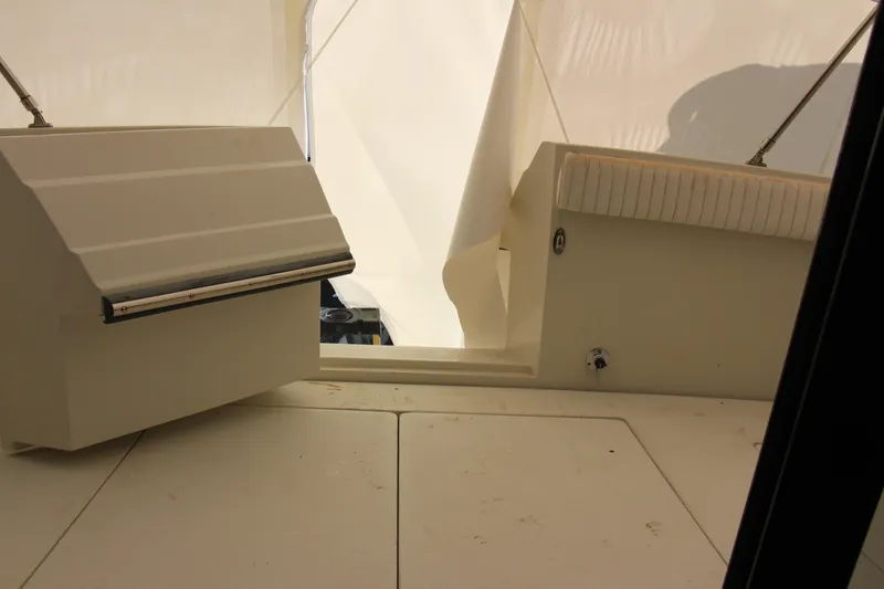 Slide: The Image of 1995 Carver 330 Mariner boat interior with white seating and storage compartments. - 23