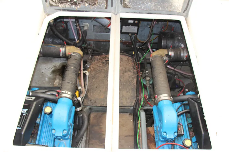 Slide: The Image of Engine compartment of a 1995 Carver 330 Mariner boat, showcasing dual engines and wiring. - 24