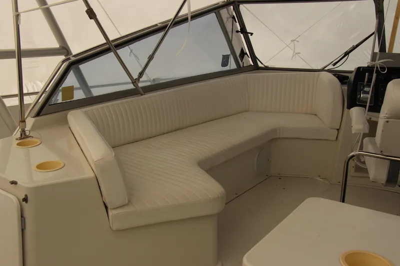 Slide: The Image of 1995 Carver 330 Mariner interior with white seating and helm station. - 26