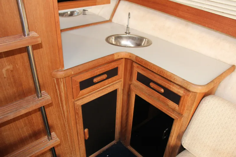 Slide: The Image of 1995 Carver 330 Mariner interior with wooden cabinetry and compact sink. - 31