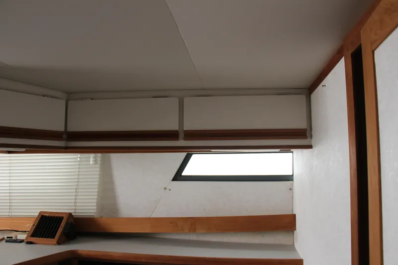 Slide: The Image of Interior of 1995 Carver 330 Mariner with wood accents and window blinds. - 38