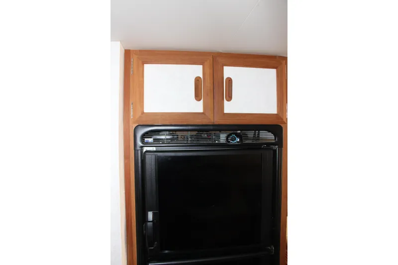 Slide: The Image of Wooden cabinets and black appliance in 1995 Carver 330 Mariner interior. - 40