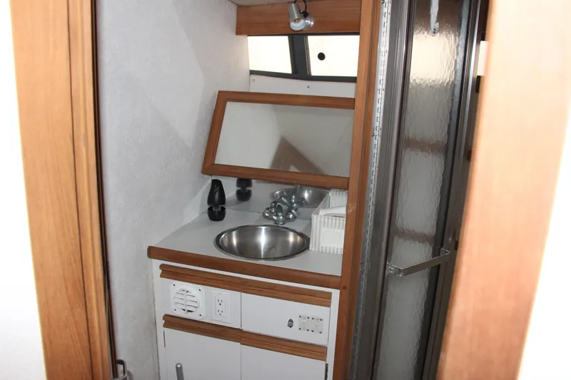 Slide: The Image of 1995 Carver 330 Mariner bathroom with sink, mirror, and shower. - 42