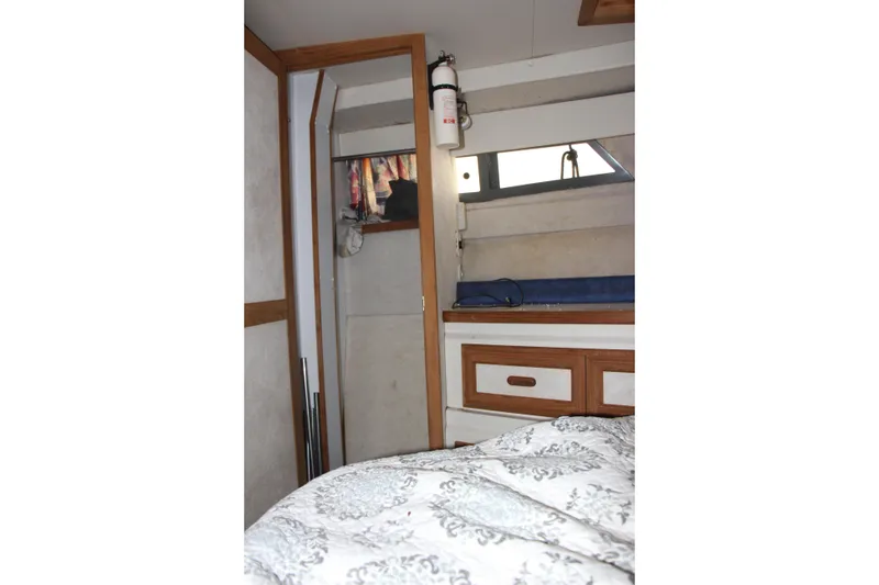 Slide: The Image of Interior of 1995 Carver 330 Mariner boat with bed, drawers, and window. - 47