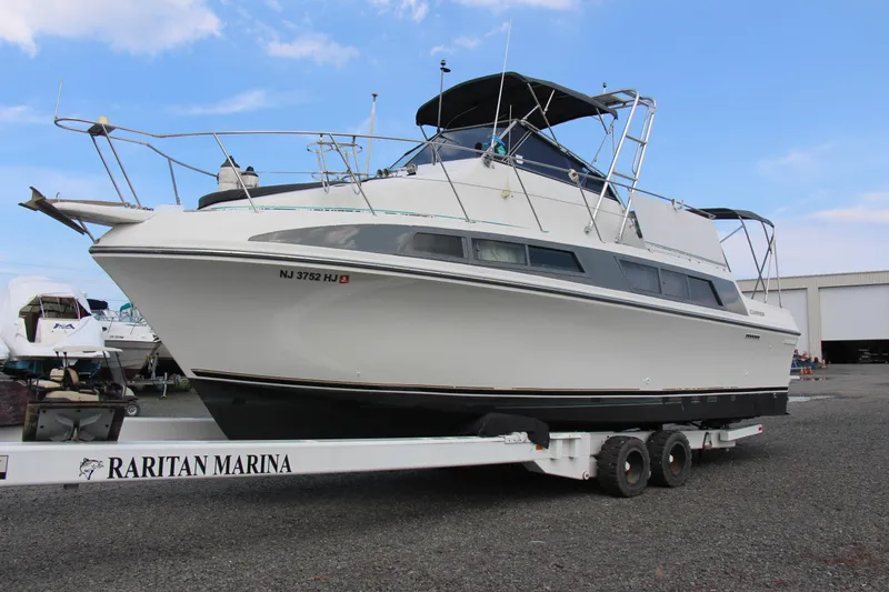 Slide: The Image of 1995 Carver 330 Mariner boat on trailer at Raritan Marina, clear sky background. - 6
