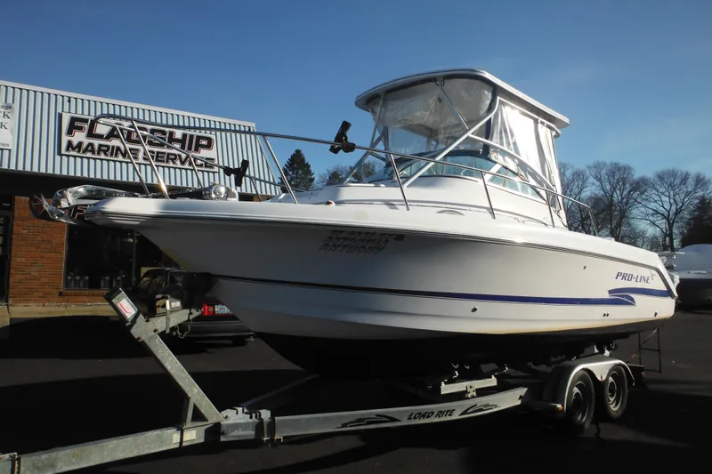 Slide: The Image of 2000 Pro-Line 23 Walkaround boat on trailer at Flagship Marine Service. - 13