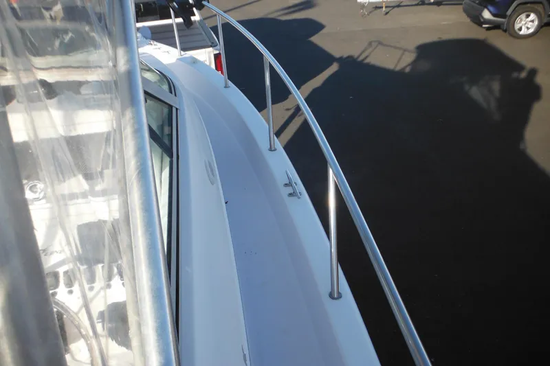 Slide: The Image of 2000 Pro-Line 23 Walkaround boat deck with stainless steel railing, viewed from above. - 15
