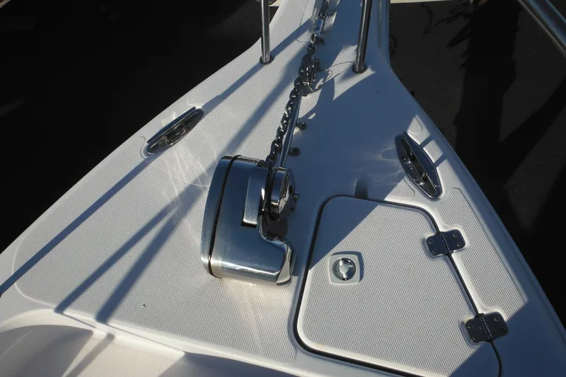 Slide: The Image of 2000 Pro-Line 23 Walkaround boat deck with anchor chain and hatch. - 18
